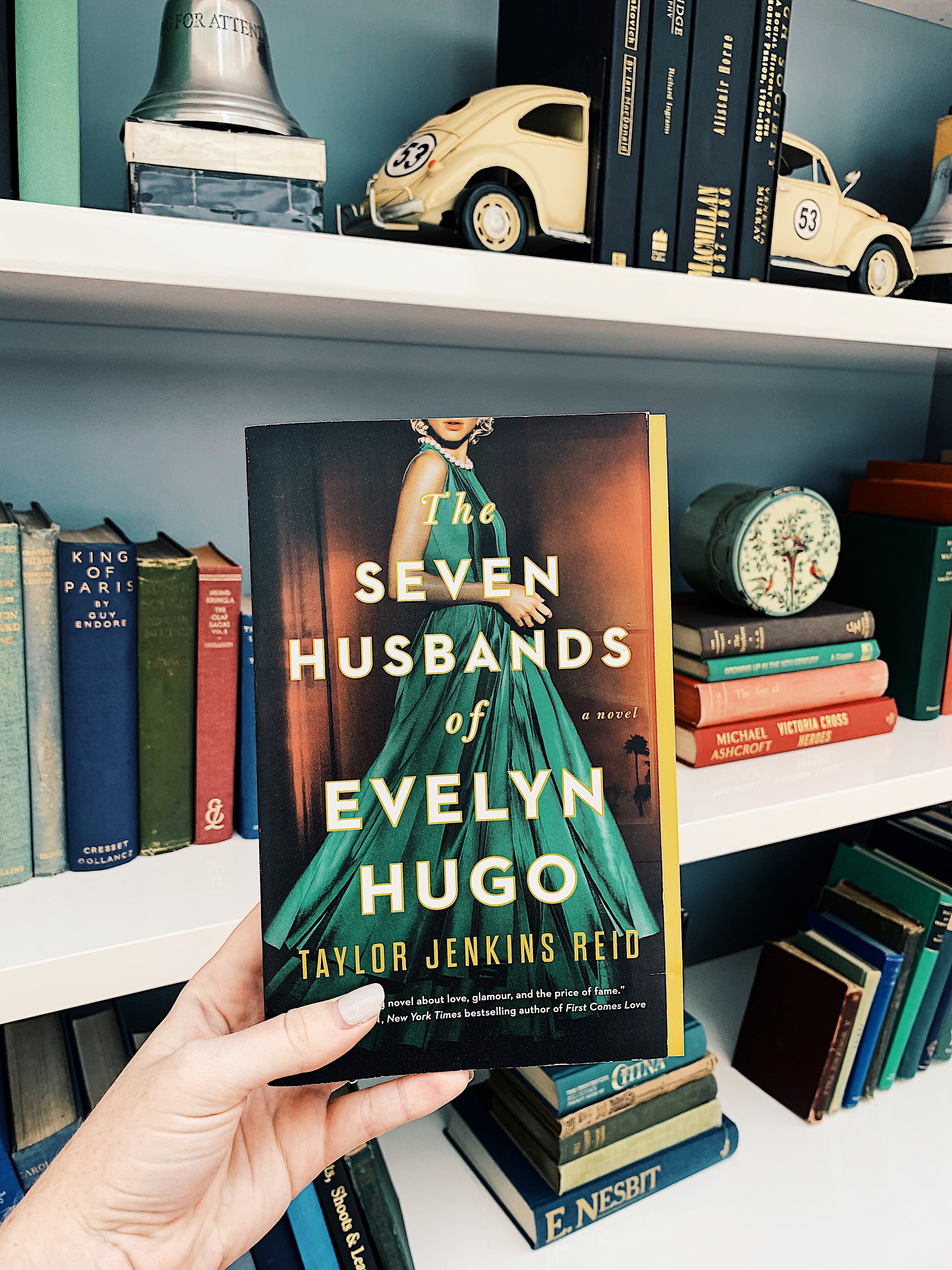 The Seven Husbands of Evelyn Hugo by Taylor Jenkins Reid in hand